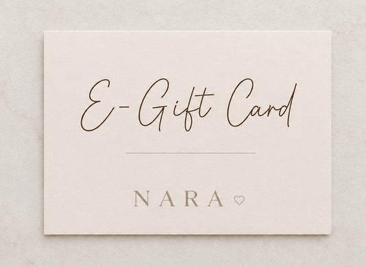 NARA E-Gift Card — flat lay on marble surface showing script E-Gift Card lettering and NARA branding