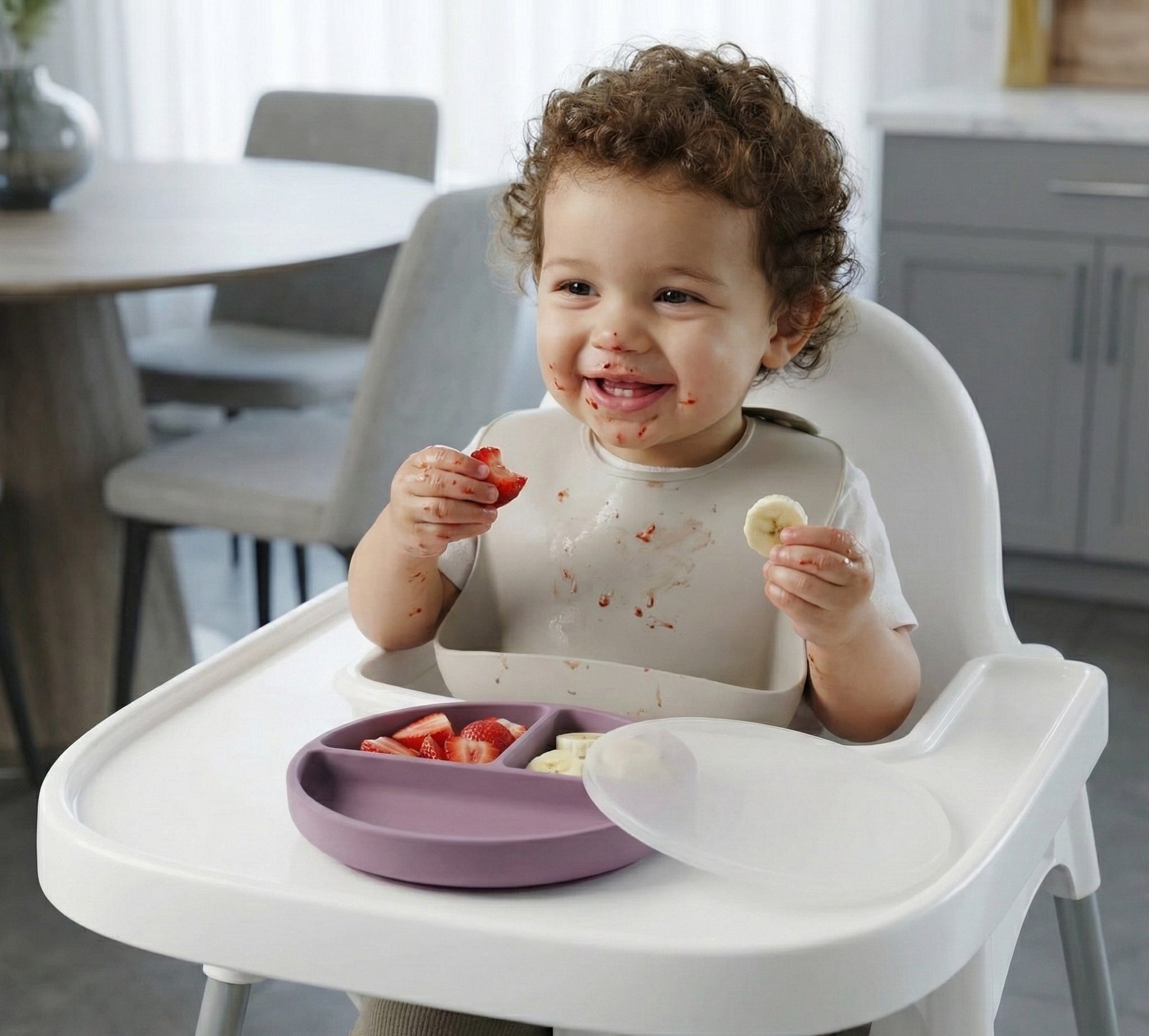 Toddler eating fruit from NARA Silicone Suction Plate and Lid in Pale Mauve
