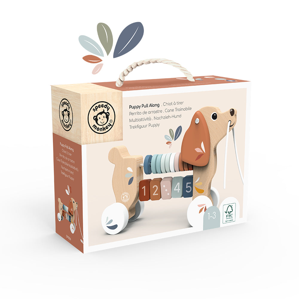 Speedy Monkey Puppy Pull Along in its retail gift box — FSC certified wooden pull-along toy for ages 1–3, in earthy Scandi tones. Premium baby gift by NARA.