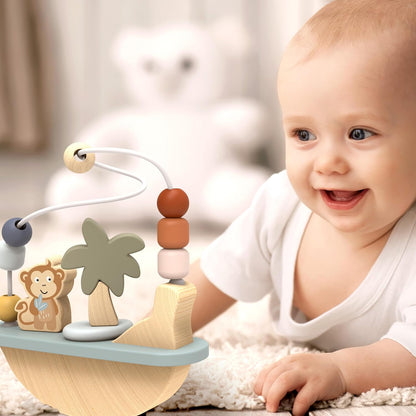 Baby smiling and reaching for a Speedy Monkey Rocking Beads Maze during tummy time. Wooden Montessori baby toy by NARA.