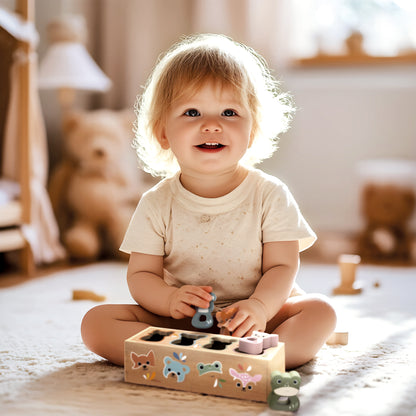 Toddler playing with the Speedy Monkey Animal Shape Box — wooden shape sorter toy for babies 12 months and up. Personalised baby gift by NARA.