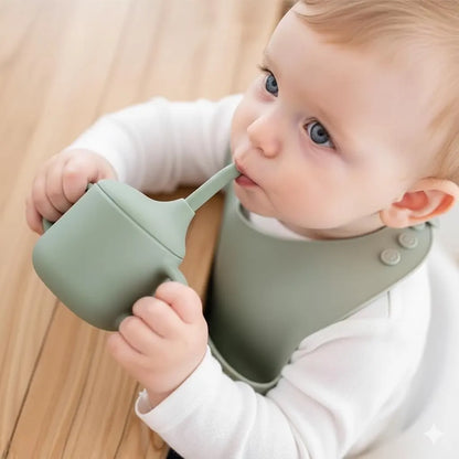 Baby drinking from NARA Silicone 3-in-1 Infant Cup in Sage Green