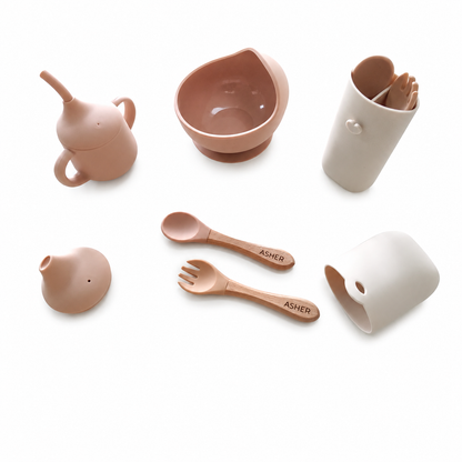 NARA First Bites silicone mealtime set in Neutral Beige — suction bowl, training cup with sippy lid, cutlery case and personalised wooden spoon and fork on white background
