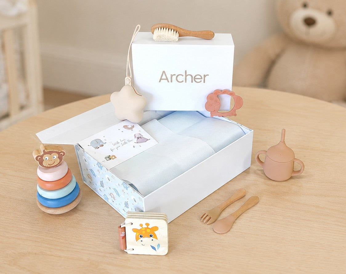 NARA Magnetic Keepsake Gift Box open on a nursery table with baby gifts