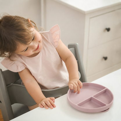 Baby using NARA silicone suction plate in Pale Mauve — divided sections keep food separate and suction base prevents spills