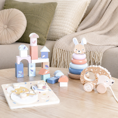 Speedy Monkey My First Toy Box contents — wooden building blocks castle, stacking rabbit, pull-along hedgehog and chick puzzle, FSC certified personalised wooden baby toys by NARA